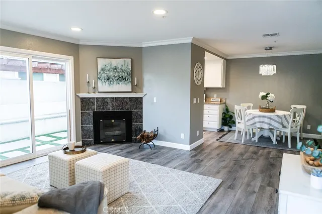 a living room with fireplace furniture and a large window