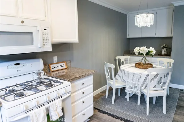 a dining room with furniture and chandelier