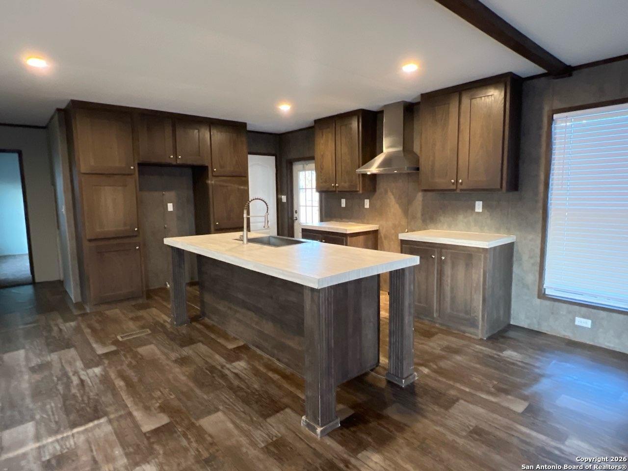 1029 Bowen Street Pleasanton, TX 78064 - Photo 1 of 4 a kitchen with kitchen island a sink stainless steel appliances and cabinets