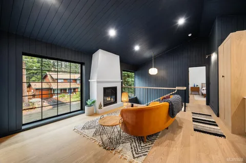 a bedroom with a large bed and a wooden floor