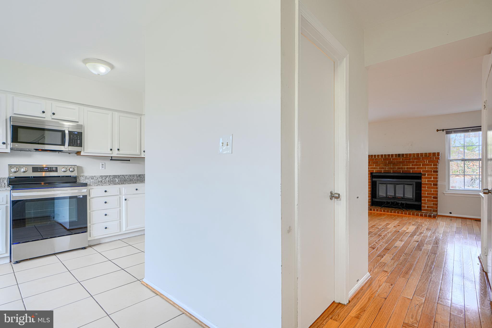 8664 Castlemill Circle Nottingham, MD 21236 - Photo 4 of 41 a kitchen with granite countertop a stove top oven and sink