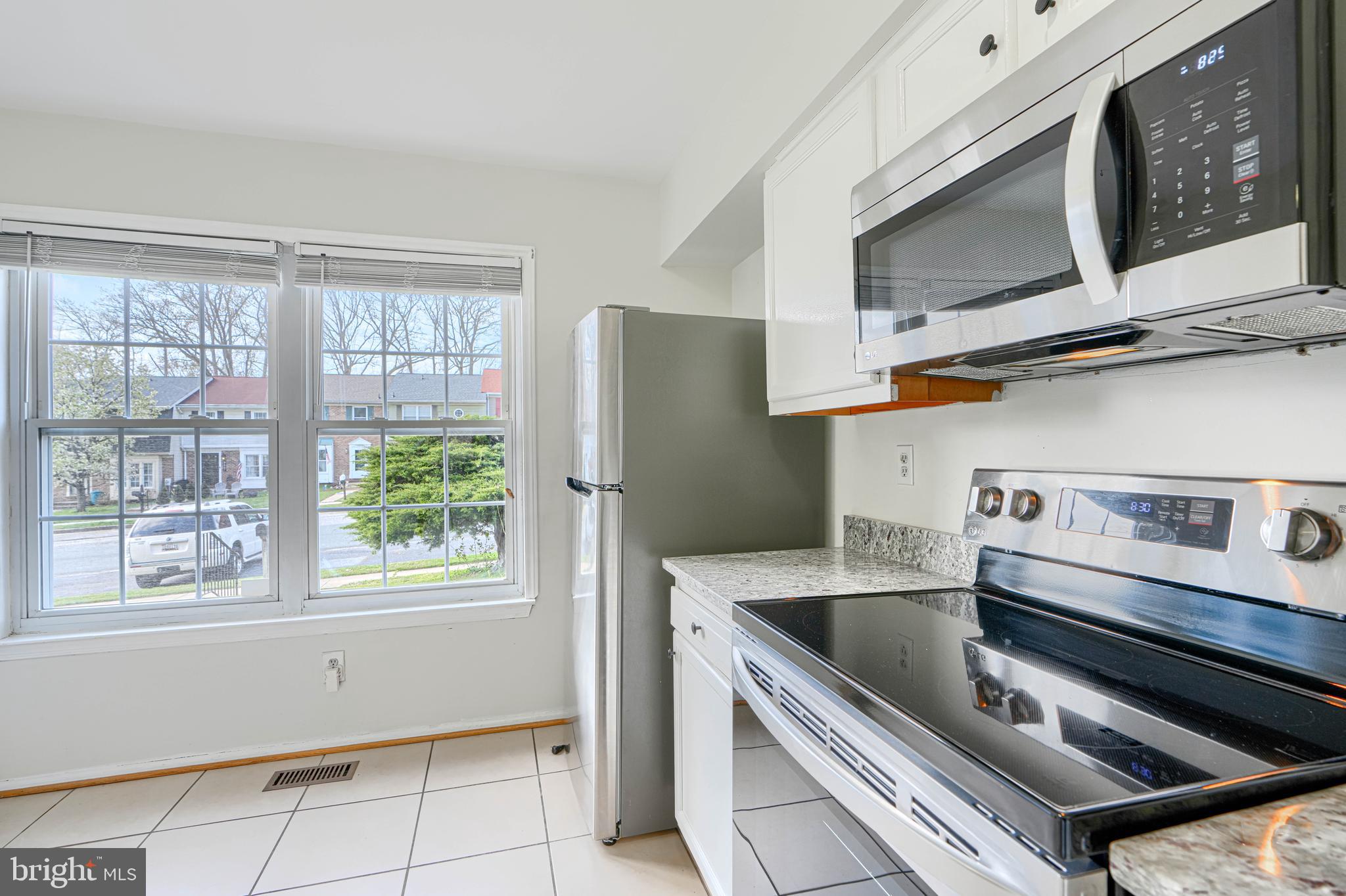 8664 Castlemill Circle Nottingham, MD 21236 - Photo 5 of 41 a kitchen with stainless steel appliances granite countertop a sink and a microwave
