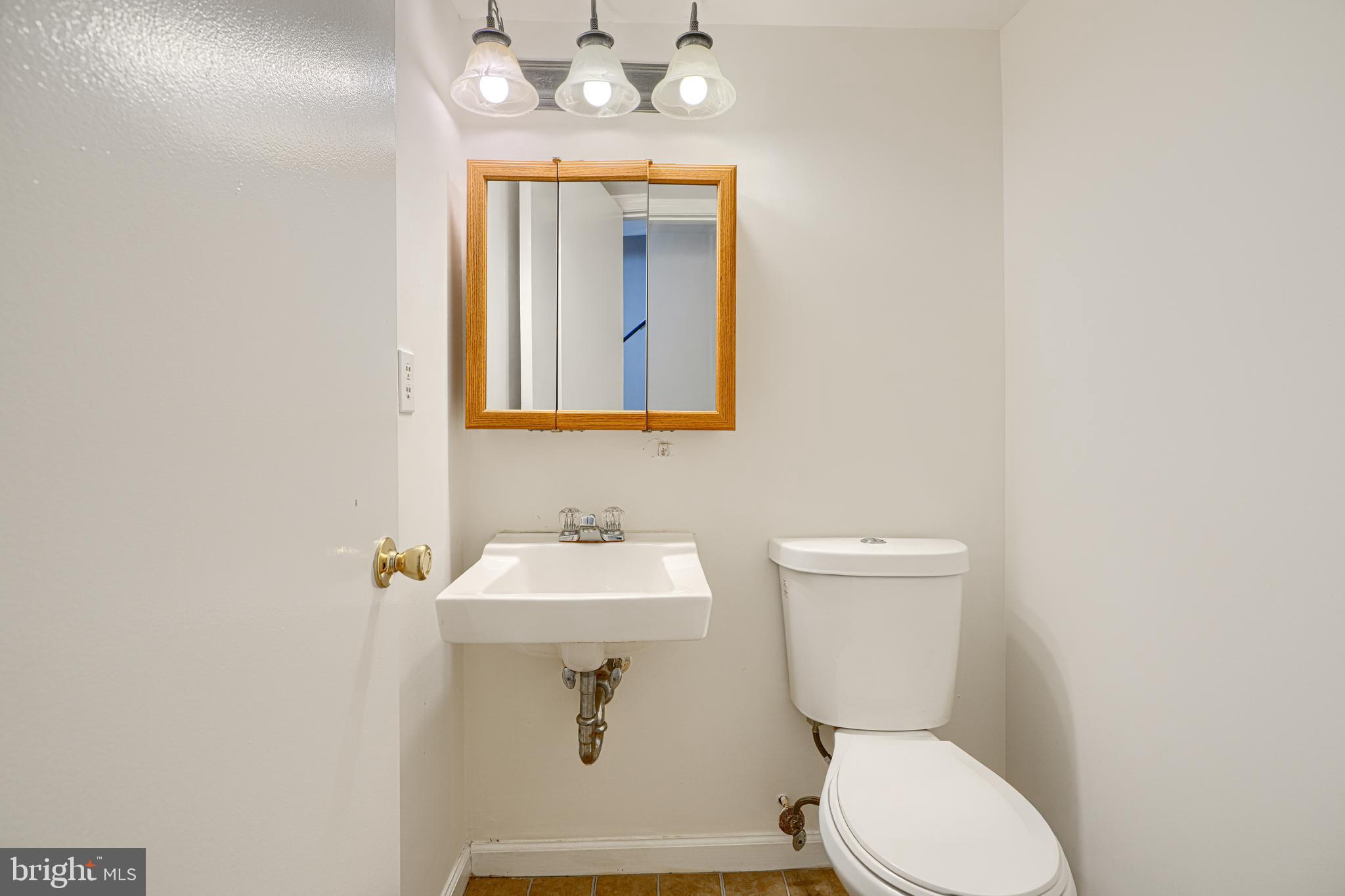 8664 Castlemill Circle Nottingham, MD 21236 - Photo 8 of 41 a bathroom with a toilet sink and mirror
