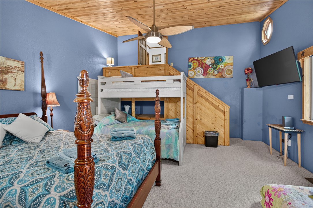 351 River Road Westminster, SC 29693 - Photo 34 of 50 A restful bedroom with wooden ceilings and carpeted floors, featuring a unique loft-style bunk bed with integrated stairs.