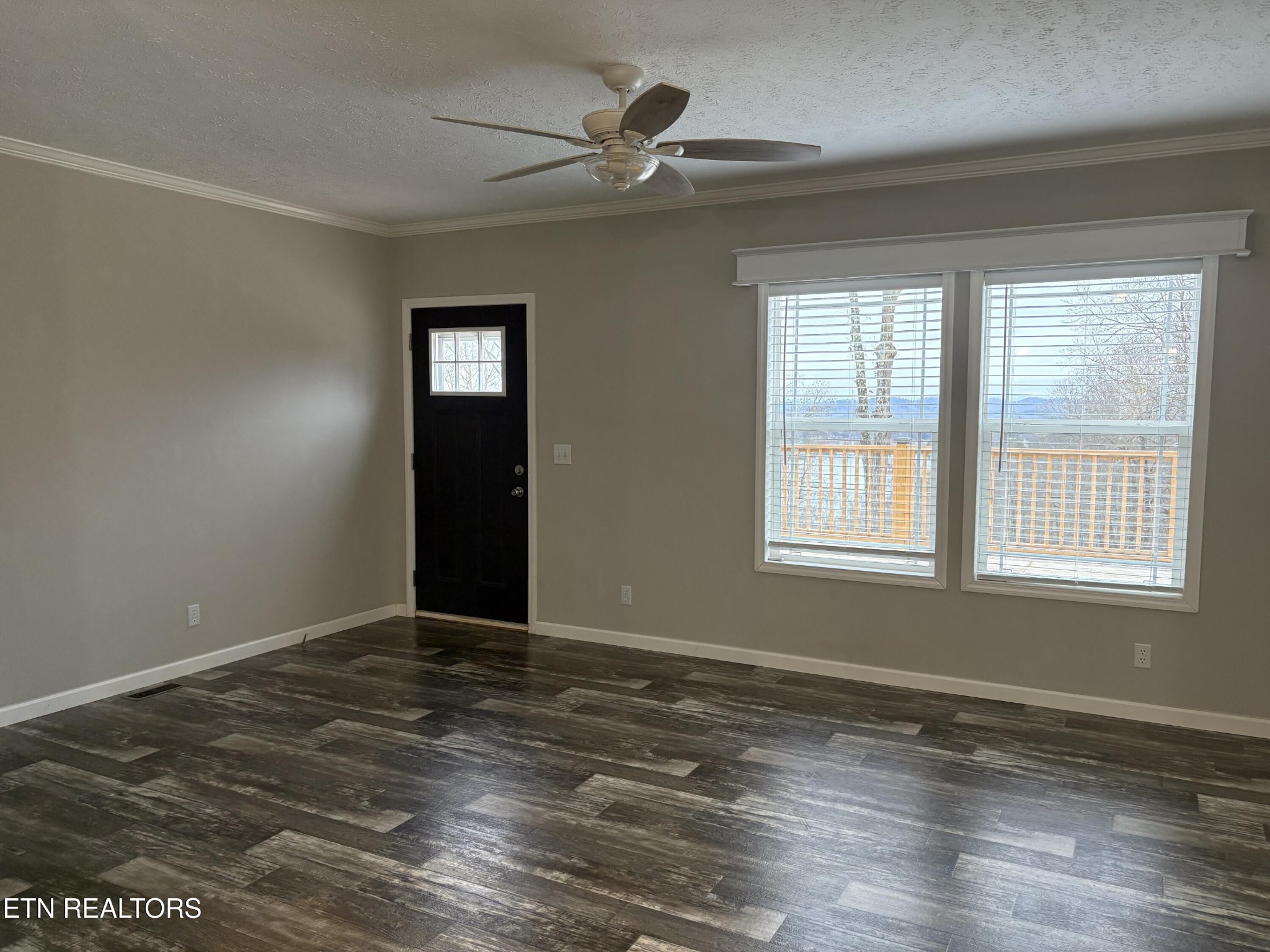 136 Hillview Road Ten Mile, TN 37880 - Photo 17 of 34 a view of an empty room with window and wooden floor