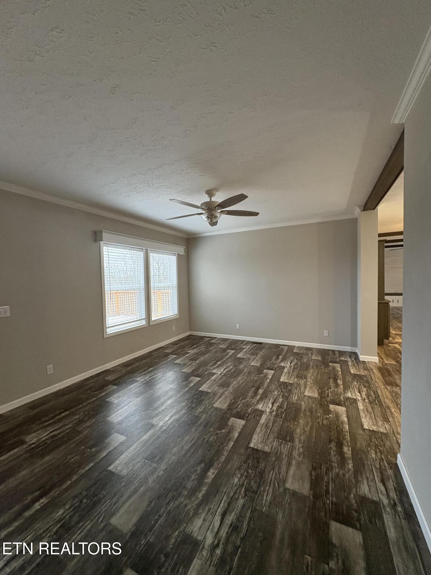 136 Hillview Road Ten Mile, TN 37880 - Photo 22 of 34 an empty room with wooden floor cabinet and windows