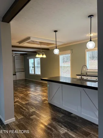 a view of a kitchen with a sink and window