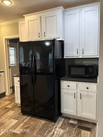a kitchen with a refrigerator and cabinets
