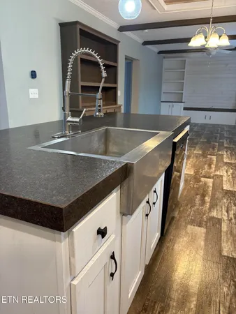 a kitchen with stainless steel appliances granite countertop a sink and a stove