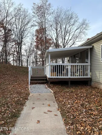 a view of a yard with wooden fence
