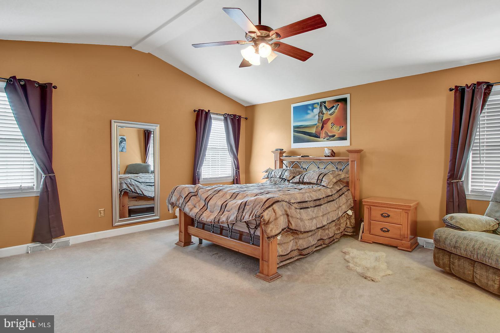 109 Atlantic Avenue Sinking Spring, PA 19608 - Photo 12 of 25 a spacious bedroom with a bed and a chandelier