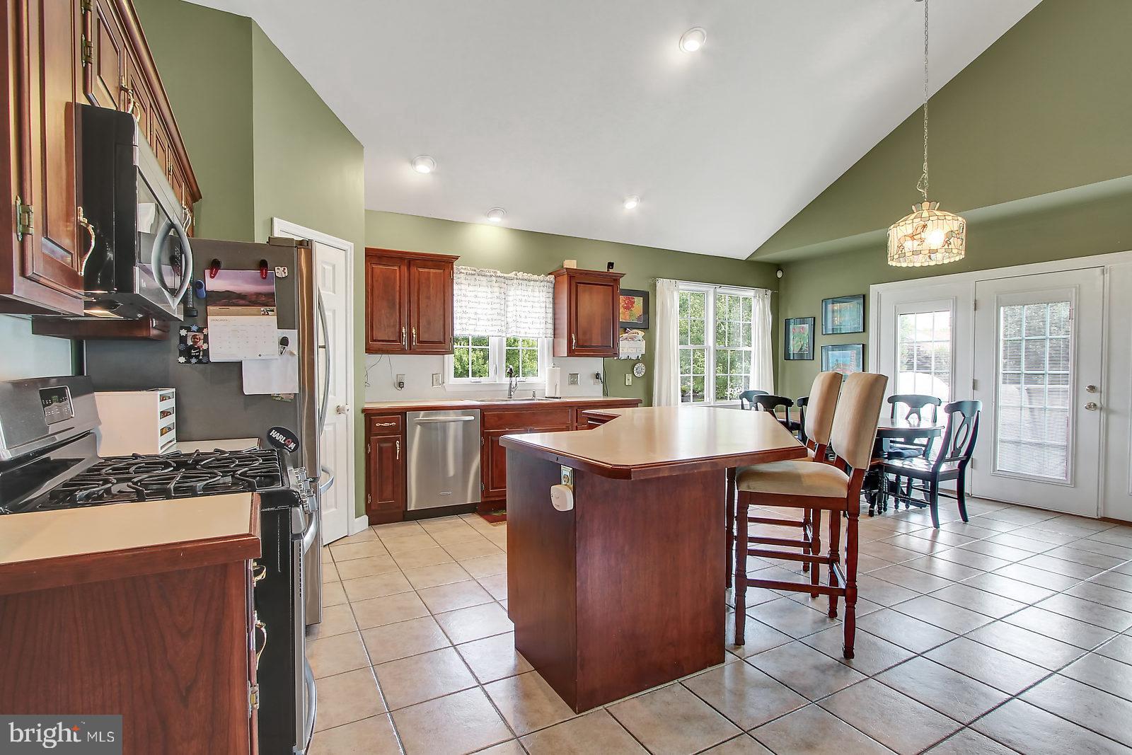 109 Atlantic Avenue Sinking Spring, PA 19608 - Photo 6 of 25 a kitchen with stainless steel appliances granite countertop table chairs and a refrigerator