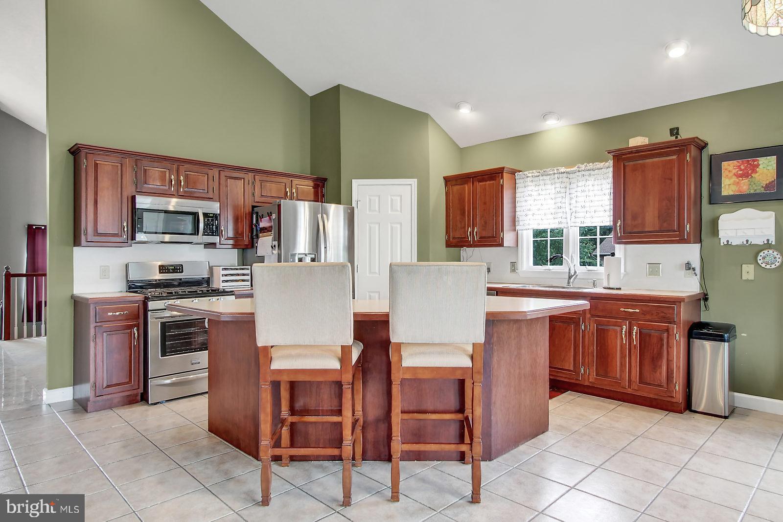 109 Atlantic Avenue Sinking Spring, PA 19608 - Photo 7 of 25 a kitchen with stainless steel appliances a refrigerator sink stove dining table and chairs