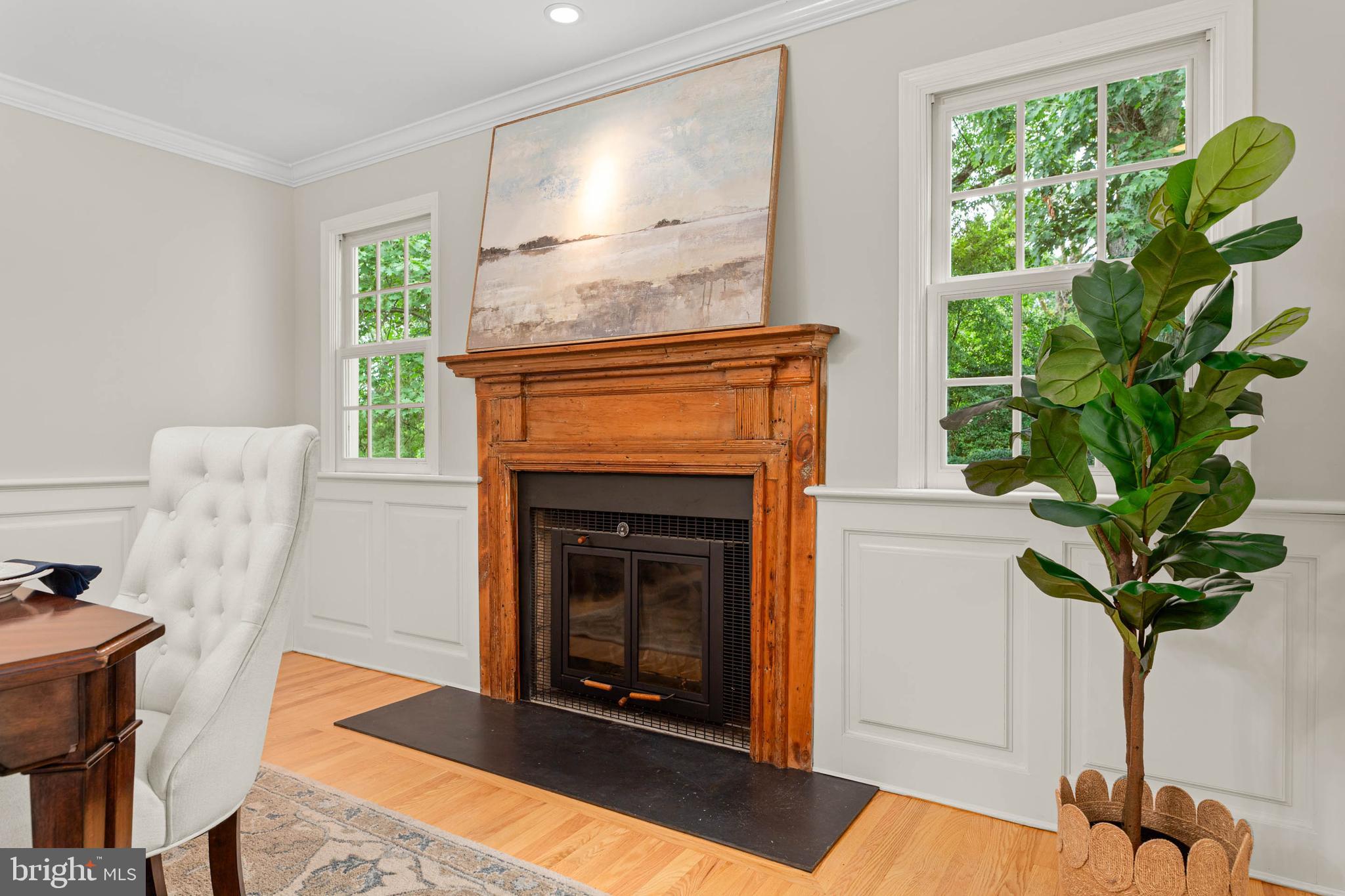 240 Church Road Devon, PA 19333 - Photo 12 of 75 a living room with a fireplace a potted plant and a large window
