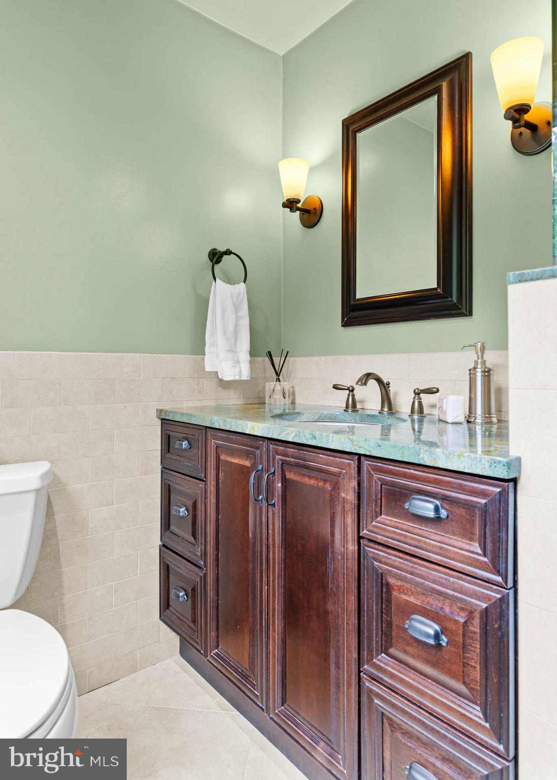 240 Church Road Devon, PA 19333 - Photo 43 of 75 a bathroom with a granite countertop toilet sink and mirror
