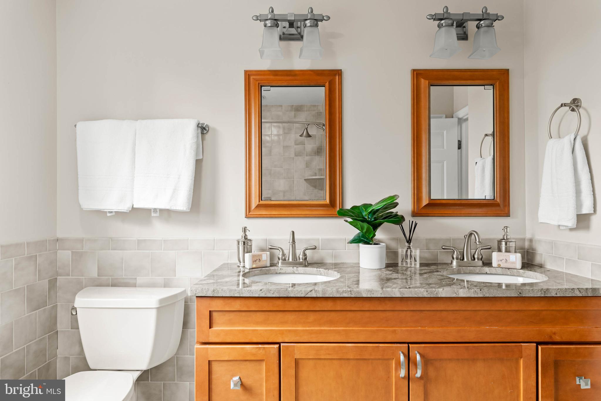 240 Church Road Devon, PA 19333 - Photo 47 of 75 a bathroom with a toilet sink and mirror