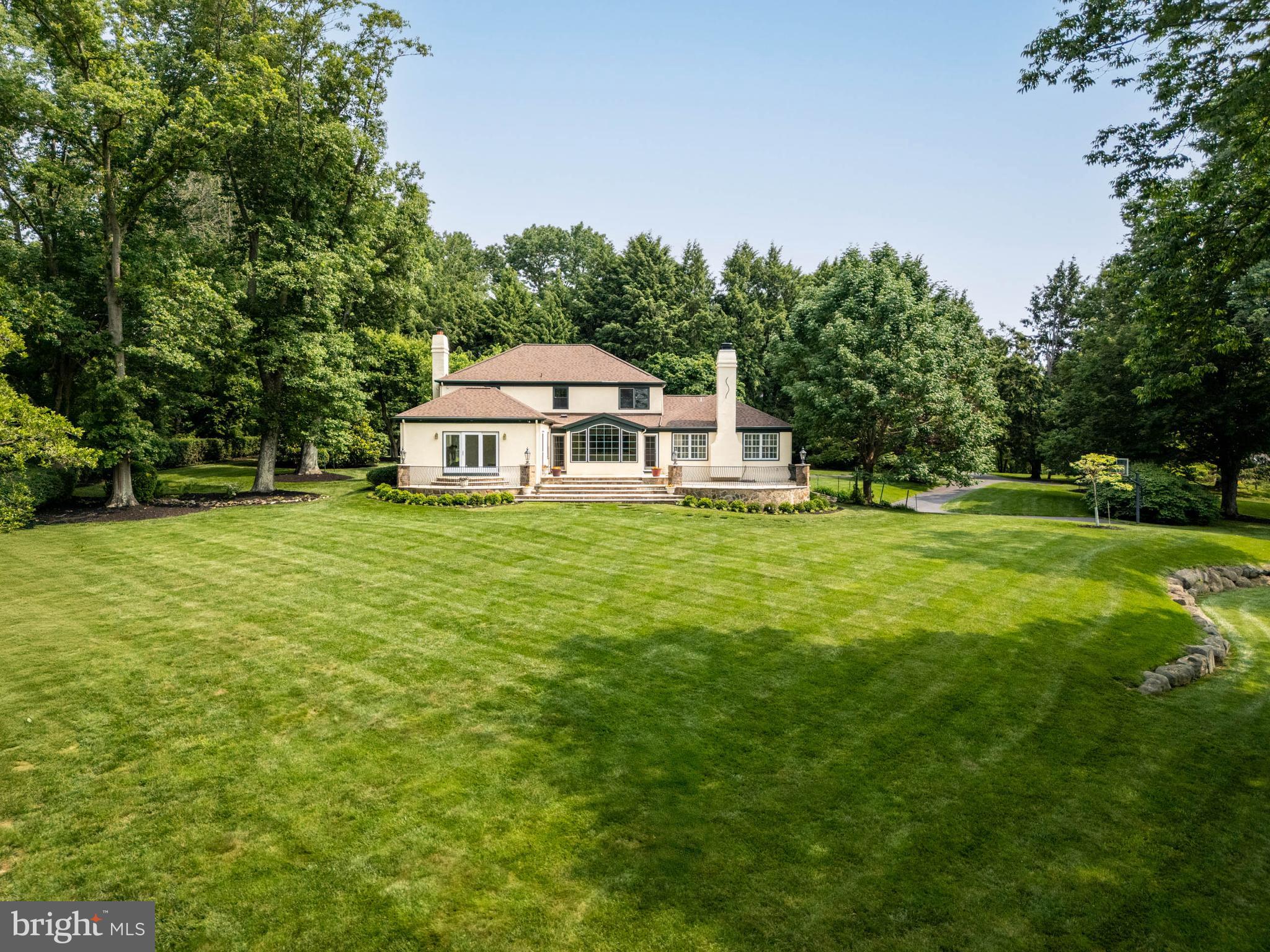 240 Church Road Devon, PA 19333 - Photo 62 of 75 a white house with a big yard and large trees