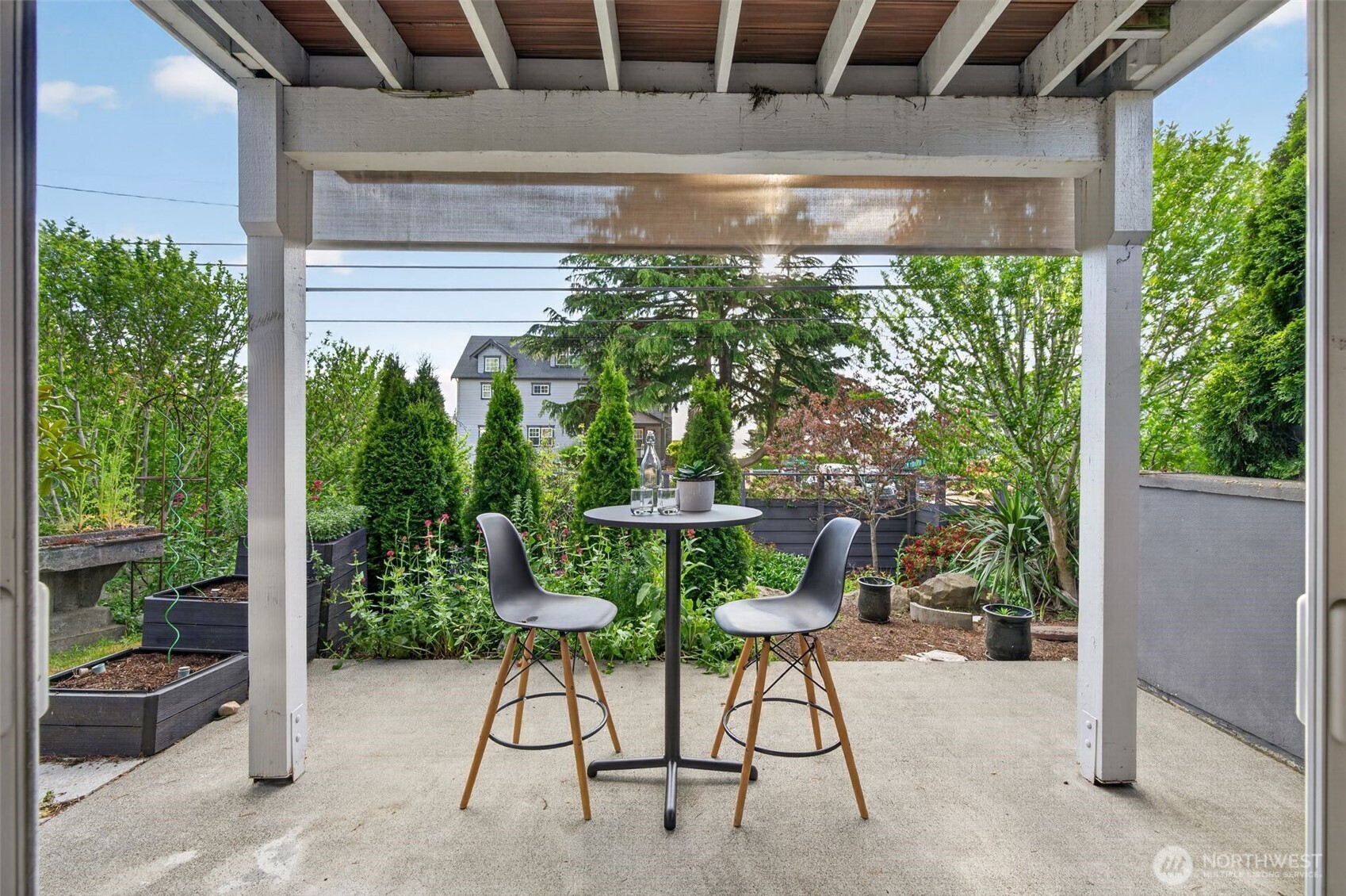7700 California Avenue Southwest Seattle, WA 98136 - Photo 5 of 40 a view of a chair and tables in the back yard of a house
