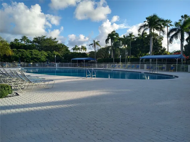 a view of swimming pool with outdoor seating and plants