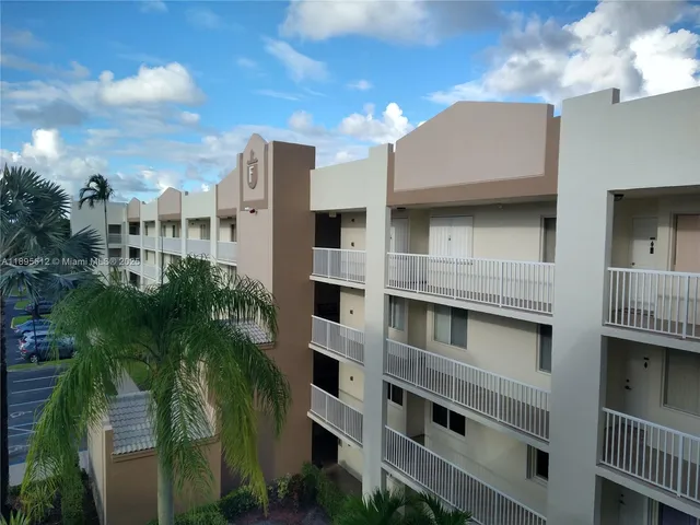 a view of a building with a yard