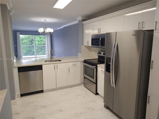 a kitchen with a sink stove and refrigerator