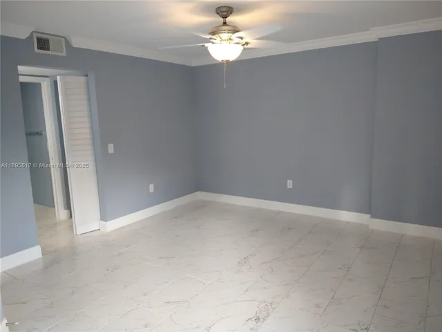 en empty room with windows and fan