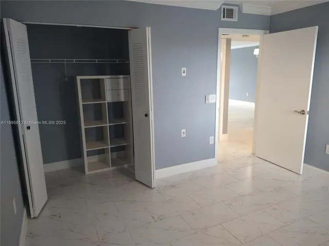 an empty room with a wooden door and a shower