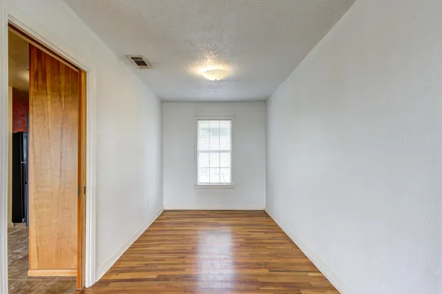 a view of wooden floor and windows in a room