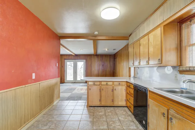 a kitchen with a sink cabinets and window