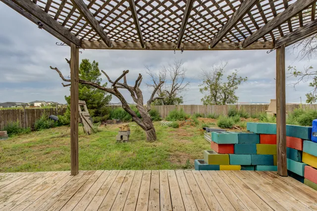 a backyard of a house with garden and outdoor seating
