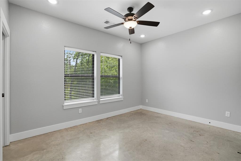 738 East Sears Street Denison, TX 75021 - Photo 17 of 32 an empty room with a window and a fan