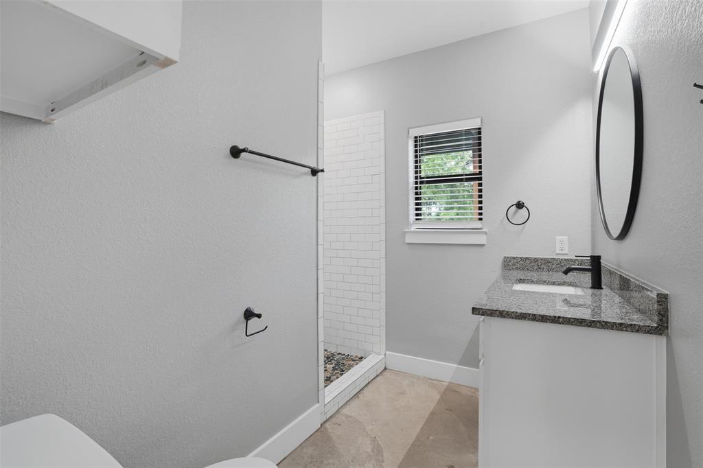 738 East Sears Street Denison, TX 75021 - Photo 21 of 32 a bathroom with a granite countertop sink toilet and shower