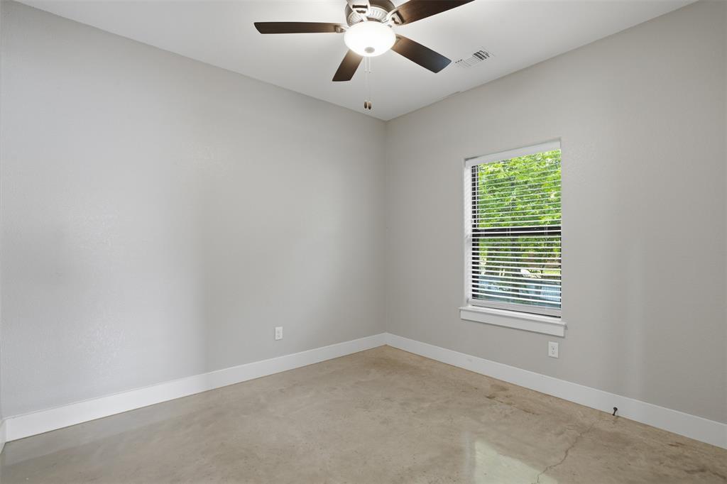 738 East Sears Street Denison, TX 75021 - Photo 27 of 32 an empty room with a window and a fan