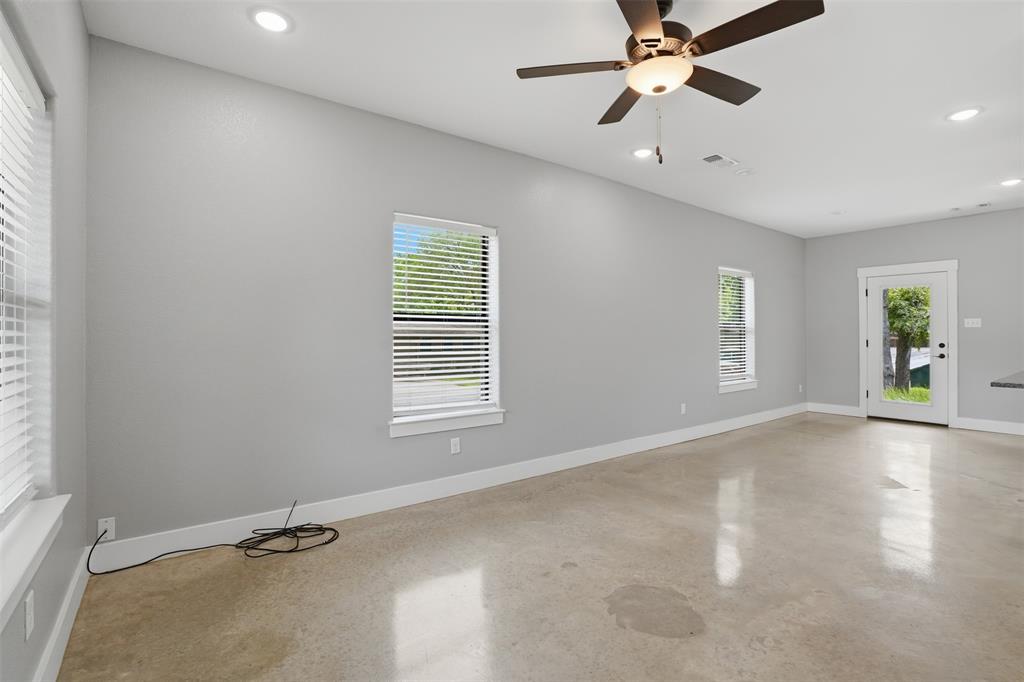 738 East Sears Street Denison, TX 75021 - Photo 3 of 32 an empty room with windows and fan
