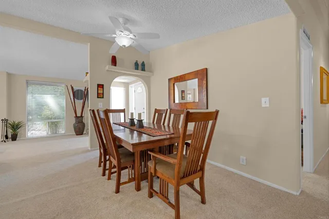 a view of a dining room with furniture and chandelier
