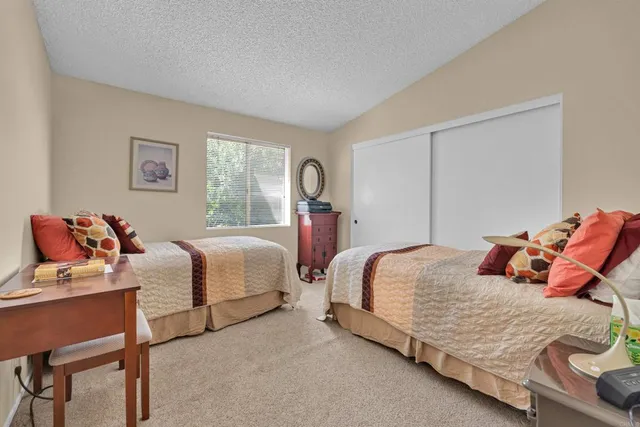 a bedroom with two beds and a dresser