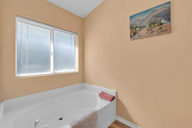 a bathroom with a tub and a window