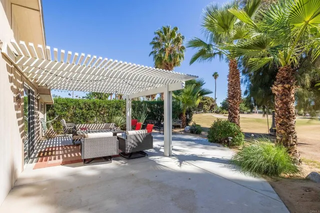 a view of a patio with couches and potted plants