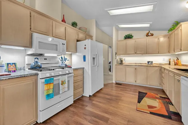 a kitchen with stainless steel appliances a stove a sink and a refrigerator