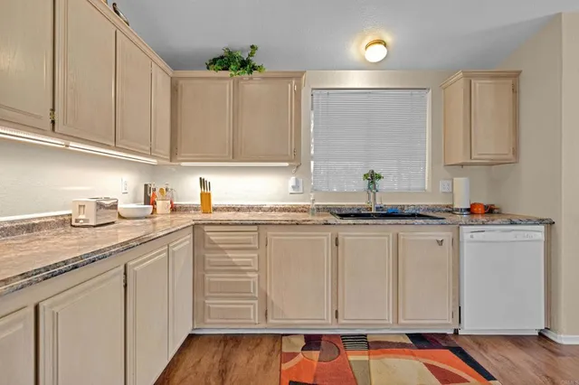 a kitchen with stainless steel appliances granite countertop a sink and cabinets