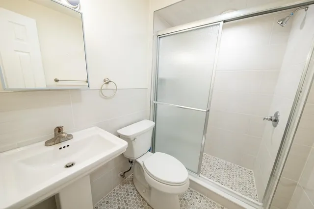 a bathroom with a sink a mirror and a toilet