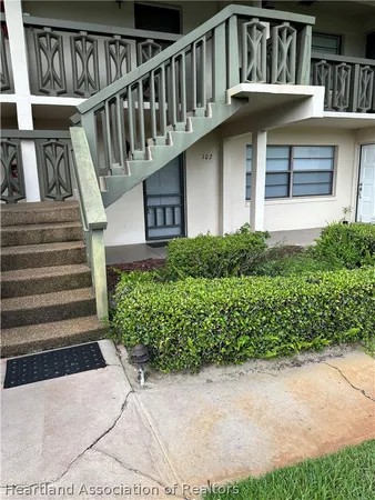 a view of a house with wooden stairs