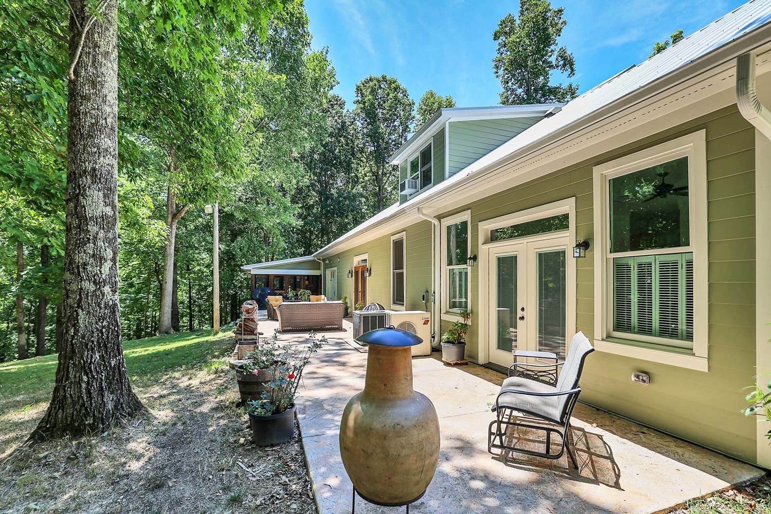5536 Boy Scout Road Franklin, TN 37064 - Photo 45 of 61 a view of a patio with chairs potted plants and a large tree