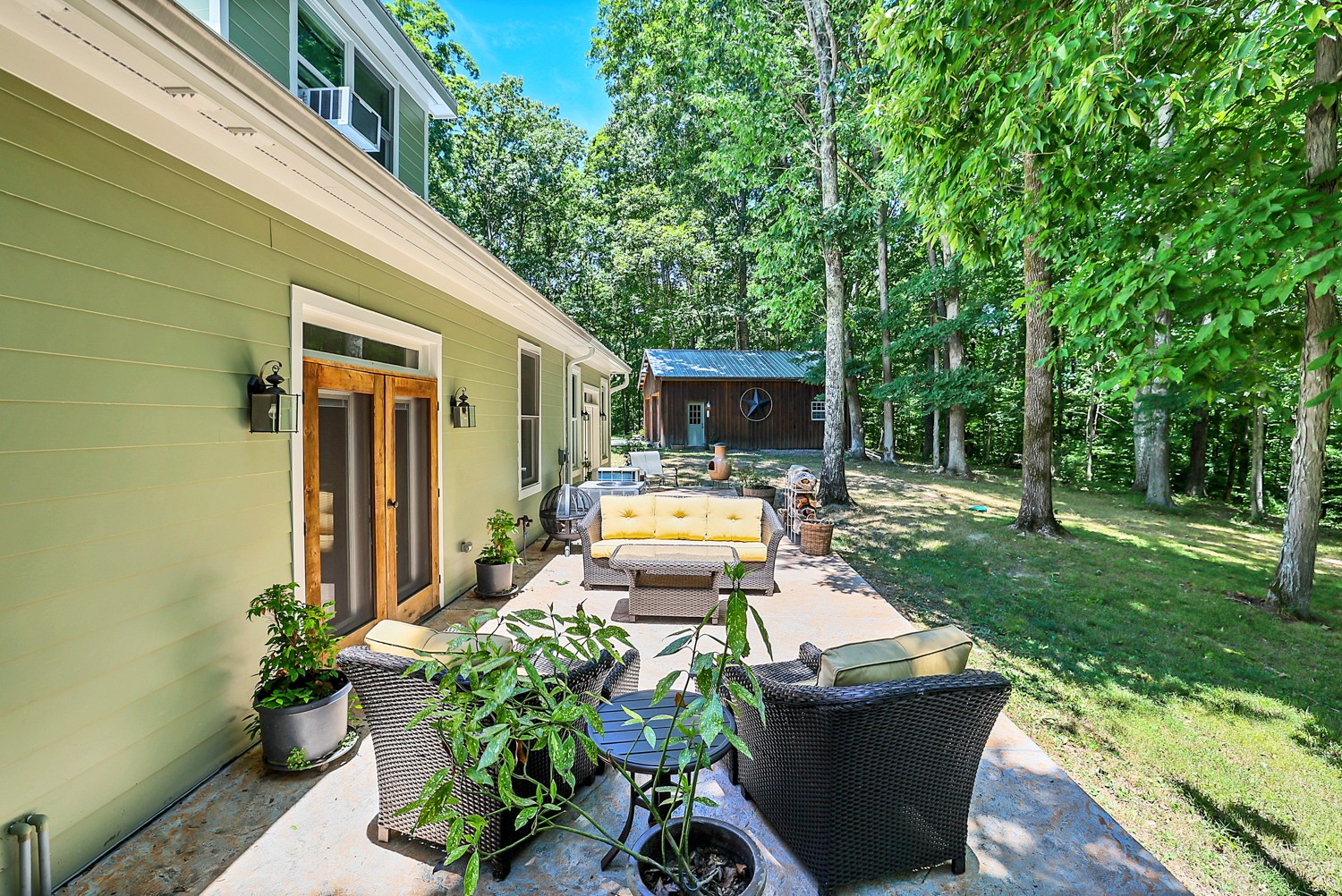 5536 Boy Scout Road Franklin, TN 37064 - Photo 48 of 61 a view of a patio with table and chairs potted plants and large tree