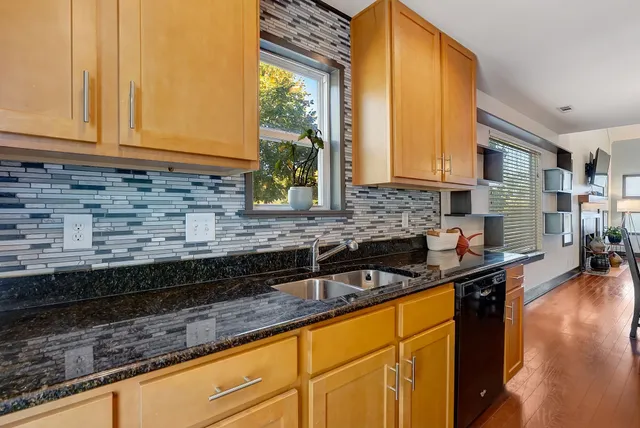 a kitchen with sink a window and cabinets