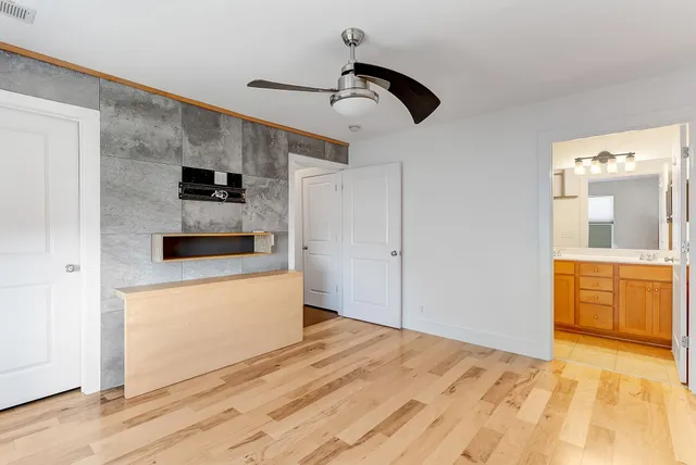 a bedroom with a bed and a view of kitchen