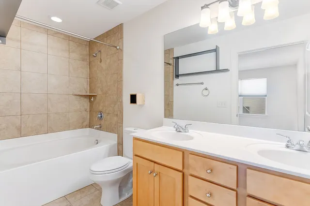 a bathroom with a sink a toilet and bathtub