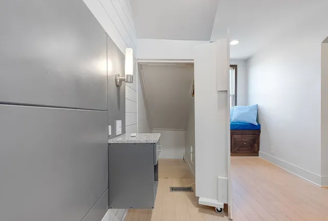 a view of hallway with cabinet and entryway