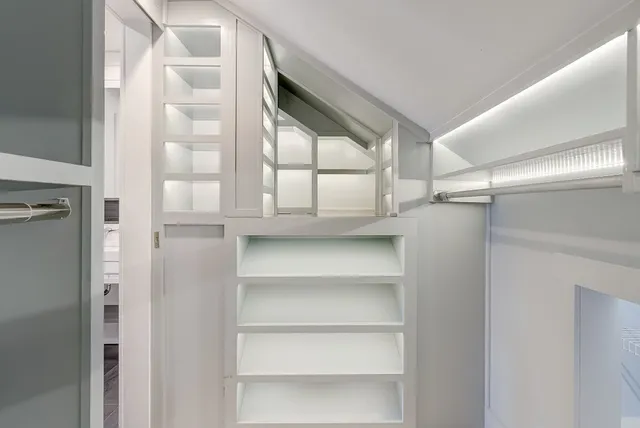 a view of walk in closet with empty racks