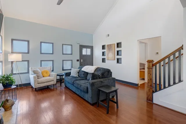a living room with furniture and a wooden floor